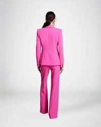 Frascara 4620 - An elegant pantsuit featuring a single-breasted jacket and wide-leg pants, perfect for formal evening occasions. The model is wearing the pantsuit in the hot pink.  back view..