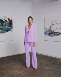Frascara 4620 - An elegant pantsuit featuring a single-breasted jacket and wide-leg pants, perfect for formal evening occasions. The model is wearing the pantsuit in the lavender.