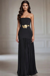 Model wearing Jovani 47000 strapless evening gown with floral waist detail and flowing pleated skirt.