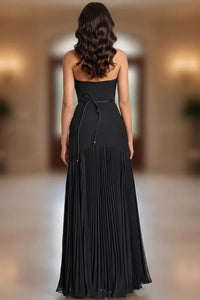Model wearing Jovani 47000 strapless evening gown with floral waist detail and flowing pleated skirt.