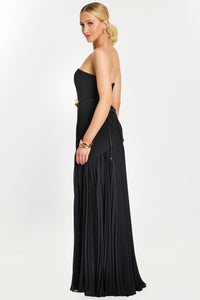 Model wearing Jovani 47000 strapless evening gown with floral waist detail and flowing pleated skirt.