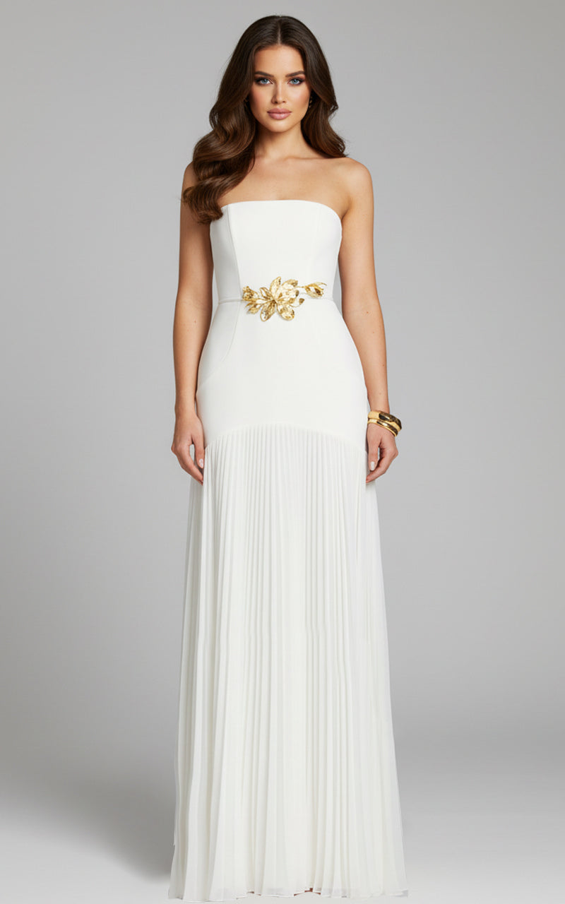 Model wearing Jovani 47000 strapless evening gown with floral waist detail and flowing pleated skirt.
