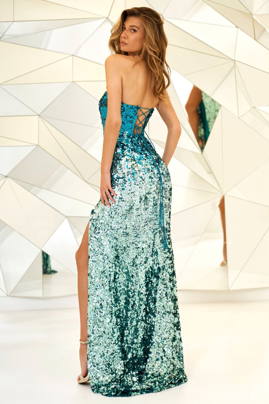 Striking Jade Ombre sequin gown by Sherri Hill, available at Madeline's in Toronto and Boca Raton. Elevate your style with this mesmerizing dress for unforgettable moments.