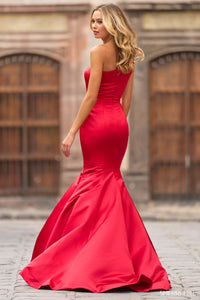 Discover elegance and sophistication with this stunning one-shoulder silk mermaid gown by Sherri Hill, available at Madeline's. Adorned with exquisite beaded embellishments on the bow, this dress is perfect for any special occasion. Shop now and turn heads with this captivating design.