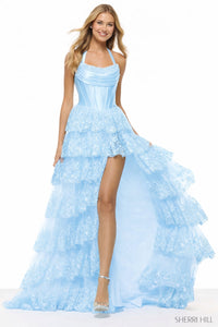 Woman wearing a light blue evening gown with a high-low design on a white background