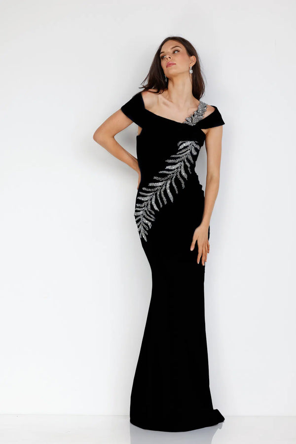 Make a statement in this stunning Terani Couture off-shoulder mother of the bride dress. The trumpet cut, asymmetrical crystal embellishments, and side slit create a glamorous silhouette. Perfect for any formal occasion. Sold by Madeline's Boutique in Toronto, Canada and Boca Raton, Florida