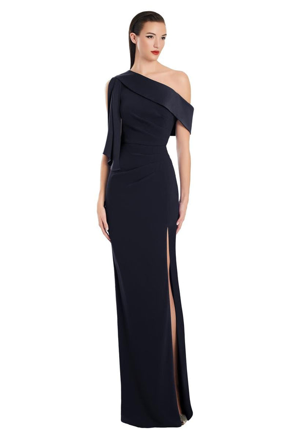 Model wearing Alexander by Daymor 3058S25 one-shoulder draped evening gown with pleated bodice, high side slit, and cascading detail.