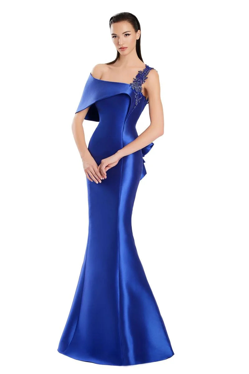 Model wearing Alexander by Daymor 3060S25 one-shoulder gown with draped back detail, fitted silhouette, and floor-length skirt.