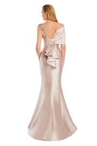 Model wearing Alexander by Daymor 3060S25 one-shoulder gown with draped back detail, fitted silhouette, and floor-length skirt.