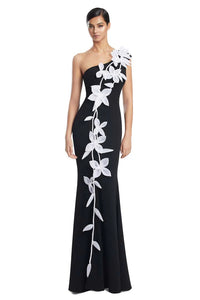 Model wearing Alexander by Daymor 3208S26 one-shoulder fitted gown with cascading floral appliqué detail.
