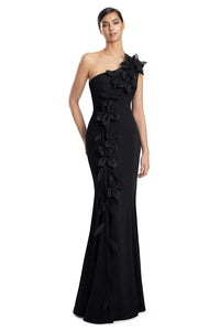 Black one-shoulder evening gown with floral details on a white background