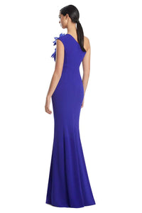 Woman wearing a blue one-shoulder dress with floral details on a white background