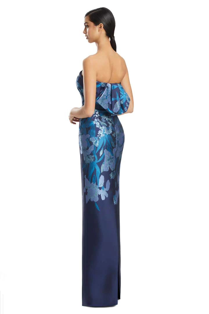 Woman wearing a blue floral strapless gown on a white background