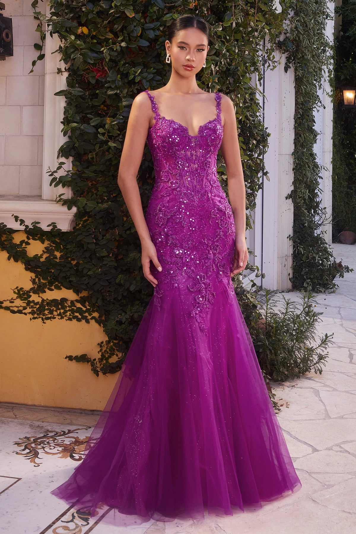 Andrea & Leo A1231 Lace Mermaid Evening Gown - A captivating fitted mermaid gown adorned with intricate lace appliqué, a sheer boned bodice, and an open scoop back for a timeless and enchanting allure.  The model is wearing the dress in Amethyst.