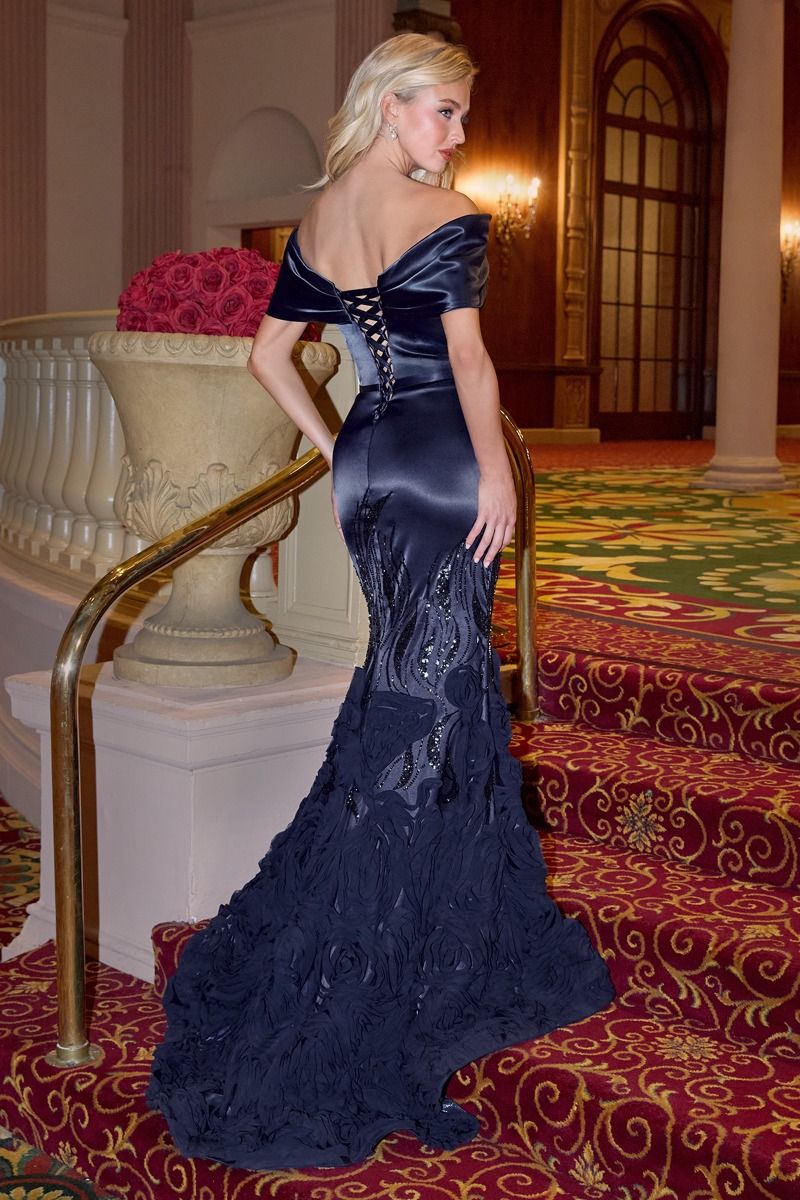 Model wearing Andrea & Leo A1482 mermaid gown with off-shoulder neckline and rosette-textured embellished skirt