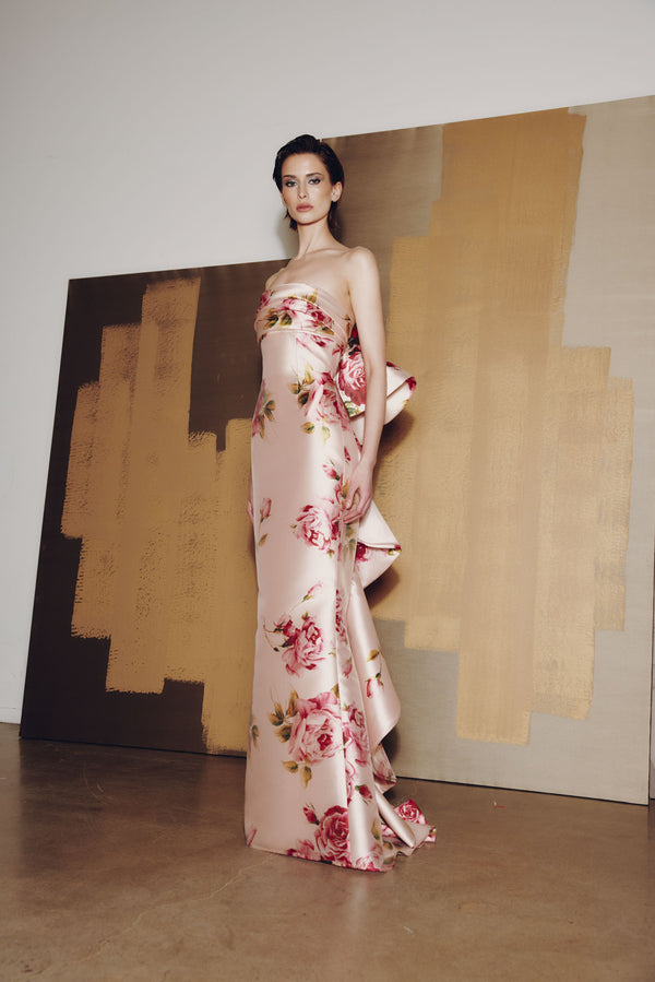 Model wearing Audrey+Brooks 6925 gown with draped bodice, fit and flare silhouette, and dramatic back ruffled train.