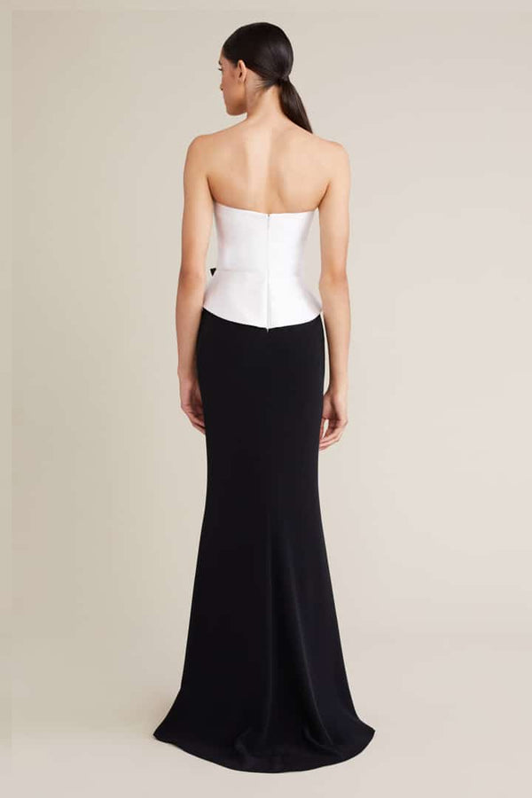 The Audrey+Brooks Strapless Corset Peplum Evening Gown in a full-length silhouette with a front bowknot detail. Perfect for formal evenings and mother of the bride or groom occasions.