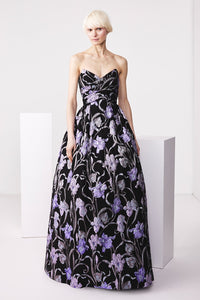 The Audrey+Brooks Enchanting Floral Ball Gown in black with a purple floral motif. A perfect choice for formal evening events, red carpet affairs, or as a Mother of the Bride or Groom gown.