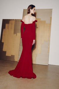 Model wearing Audrey+Brooks 6902 off-the-shoulder gown with detachable ruffled sleeves and fit-and-flare skirt.  Model is wearing the color red.  Back view.