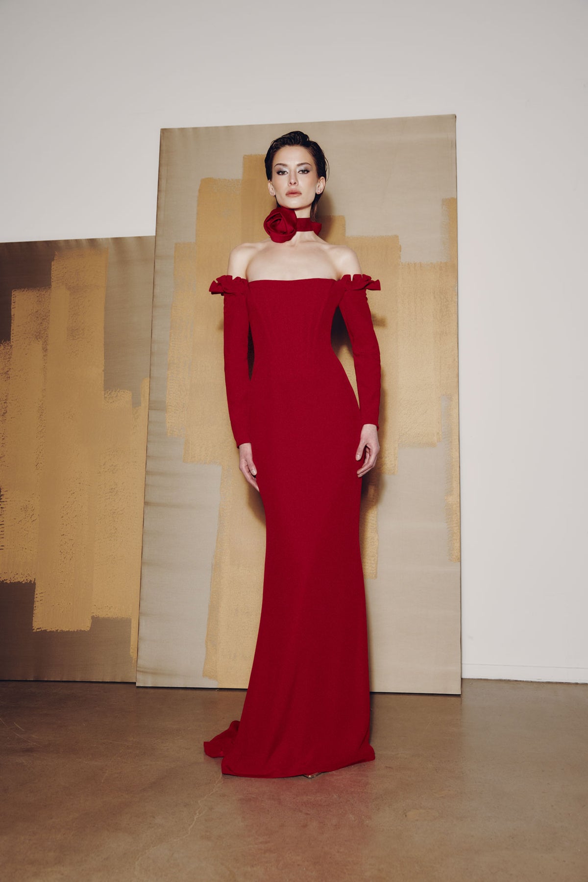 Model wearing Audrey+Brooks 6902 off-the-shoulder gown with detachable ruffled sleeves and fit-and-flare skirt.  Model is wearing the color red.  Front view.