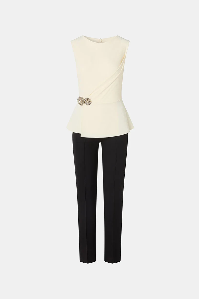 Shop the Chiara Boni SUZUE BIC BR ZP jumpsuit featuring a draped bodice, peplum waist, floral jewel detail and sleek tailored pants.