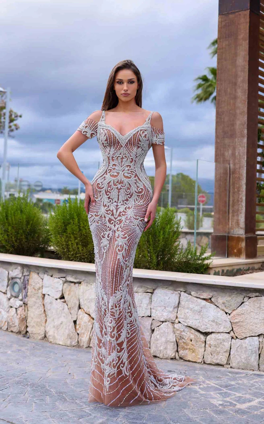 Chic & Holland HF885A Beaded Off-Shoulder Gown featuring intricate beadwork, a form-fitting silhouette, an open back, and a floor-length train.