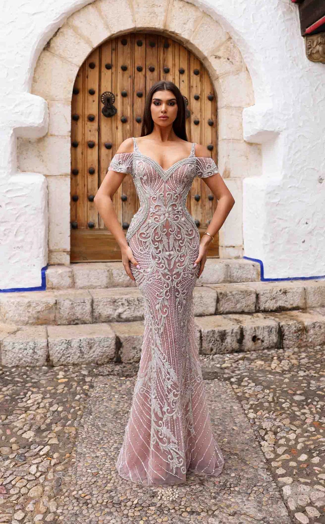 Chic & Holland HF885A Beaded Off-Shoulder Gown featuring intricate beadwork, a form-fitting silhouette, an open back, and a floor-length train.