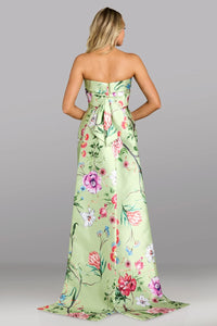 Woman wearing a strapless floral dress with a gray background