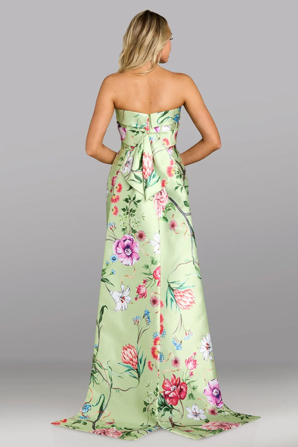 Woman wearing a strapless floral dress with a gray background
