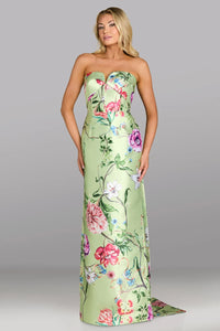 Woman wearing a strapless floral gown against a gray background