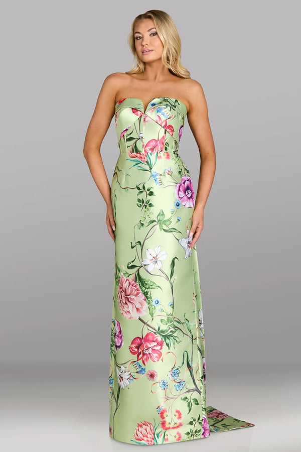 Woman wearing a strapless floral gown against a gray background