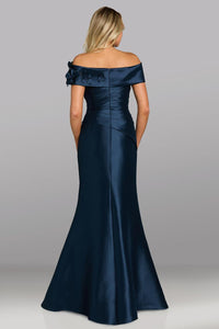 Model wearing Feriani Couture 18639 off-the-shoulder gown with draped bodice, floral appliqué detailing, and a fitted silhouette.