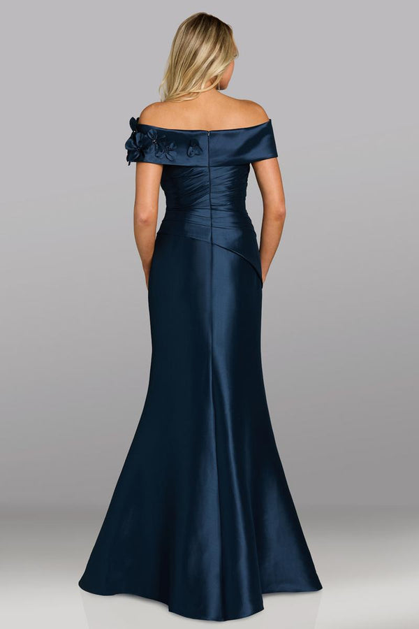 Model wearing Feriani Couture 18639 off-the-shoulder gown with draped bodice, floral appliqué detailing, and a fitted silhouette.