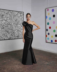 Frascara 4612 - A chic one-shoulder evening gown with an asymmetrical bow detail, perfect for formal evenings and mother of the bride or groom occasions. The model is wearing the dress in black.