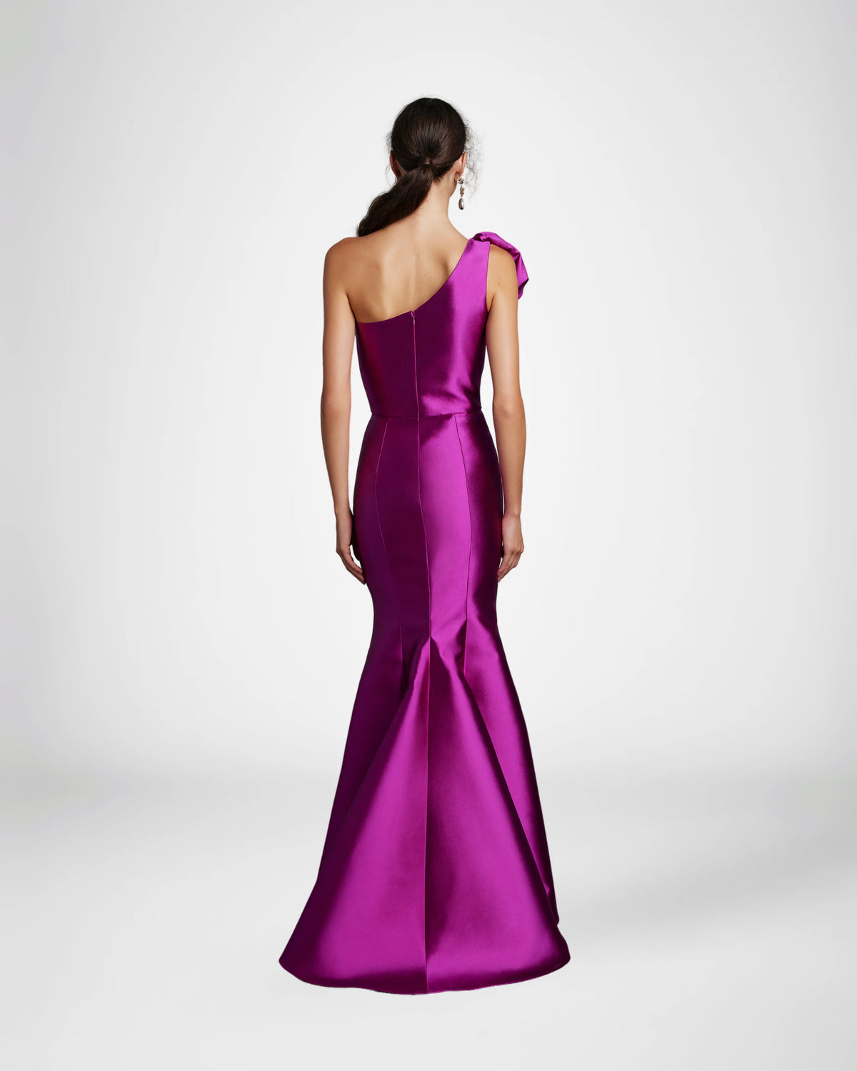 Frascara 4612 - A chic one-shoulder evening gown with an asymmetrical bow detail, perfect for formal evenings and mother of the bride or groom occasions. The model is wearing the dress in fuchsia. Back view.