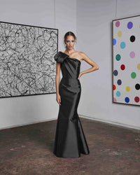 Frascara 4612 - A chic one-shoulder evening gown with an asymmetrical bow detail, perfect for formal evenings and mother of the bride or groom occasions. The model is wearing the dress in gunmetal.