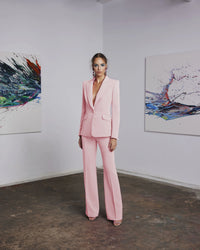 Frascara 4620 - An elegant pantsuit featuring a single-breasted jacket and wide-leg pants, perfect for formal evening occasions. The model is wearing the pantsuit in the petal pink.