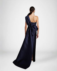 Frascara 4628 - An elegant off-the-shoulder evening gown with a draped bodice, back bow, and train, perfect for formal evenings and mother of the bride or groom occasions.  The model is wearing the dress in navy.  Back view.