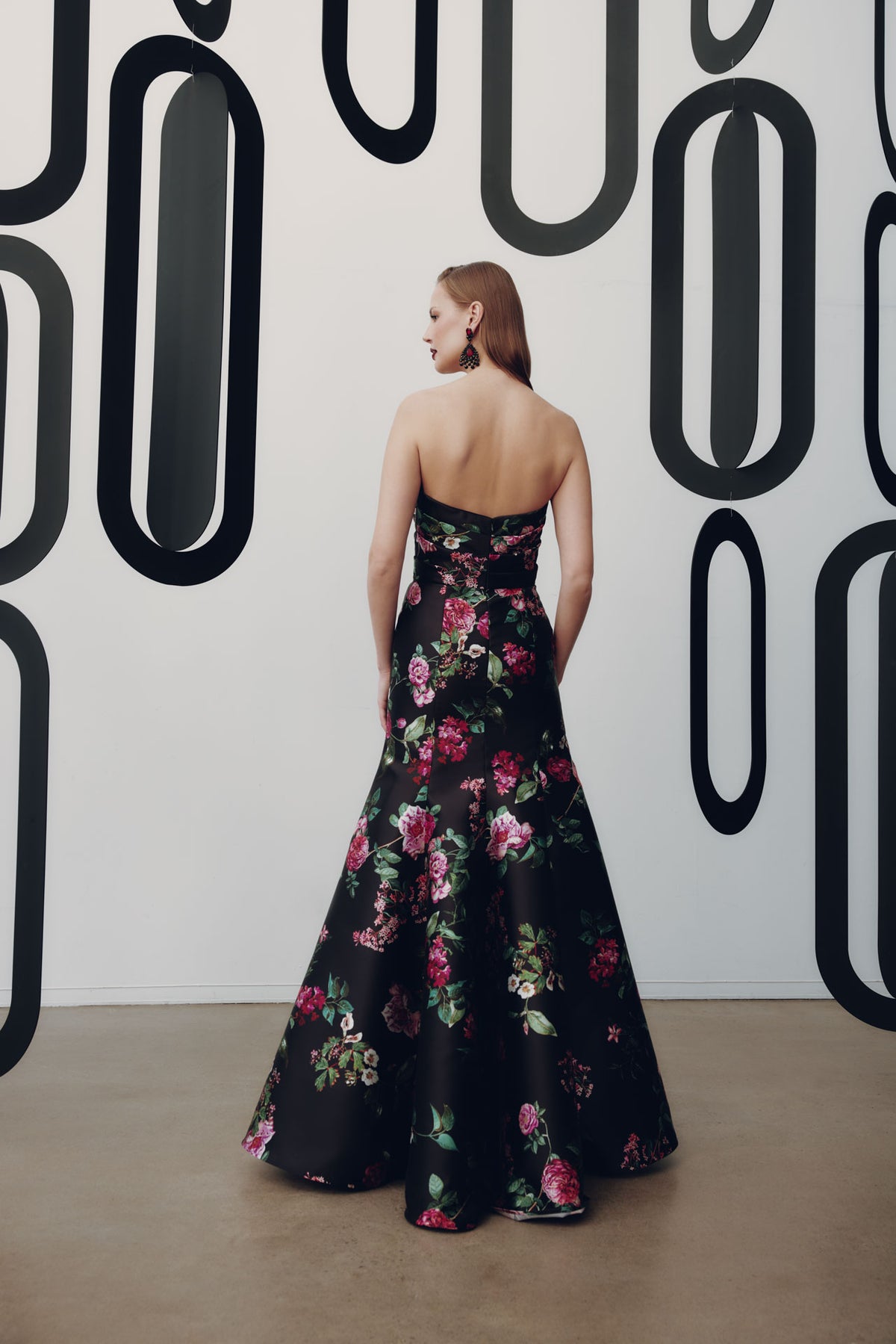 Model wearing Frascara 4954 strapless gown with draped bodice, bow detail, and mermaid skirt with crinoline, shown back.