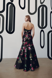 Model wearing Frascara 4954 strapless gown with draped bodice, bow detail, and mermaid skirt with crinoline, shown back.