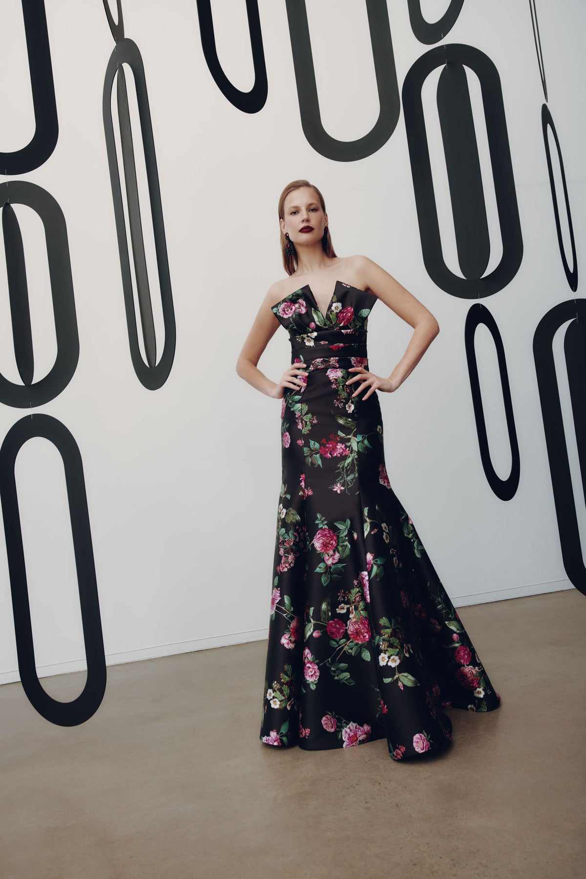 Model wearing Frascara 4954 strapless gown with draped bodice, bow detail, and mermaid skirt with crinoline, shown front.