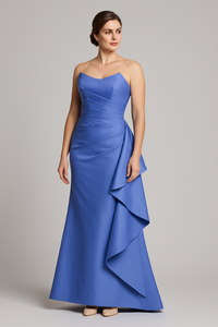 Model wearing Gia Franco 12551 strapless gown with asymmetrical draping and cascading side detail.
