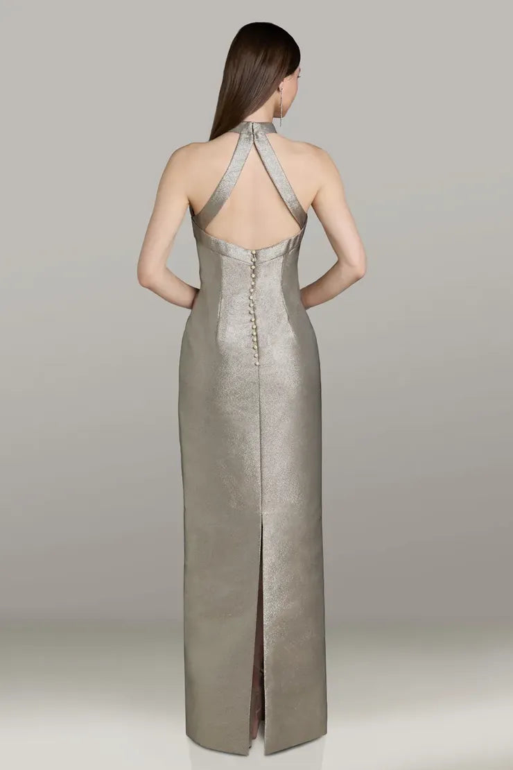 Model wearing Gia Franco 12564 halter column gown with crisscross back, button detail, and back slit.