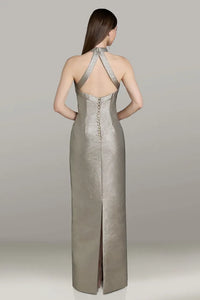 Model wearing Gia Franco 12564 halter column gown with crisscross back, button detail, and back slit.