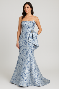 Model wearing Gia Franco 18507 strapless jacquard gown with swirl pattern and side ruffle detail.