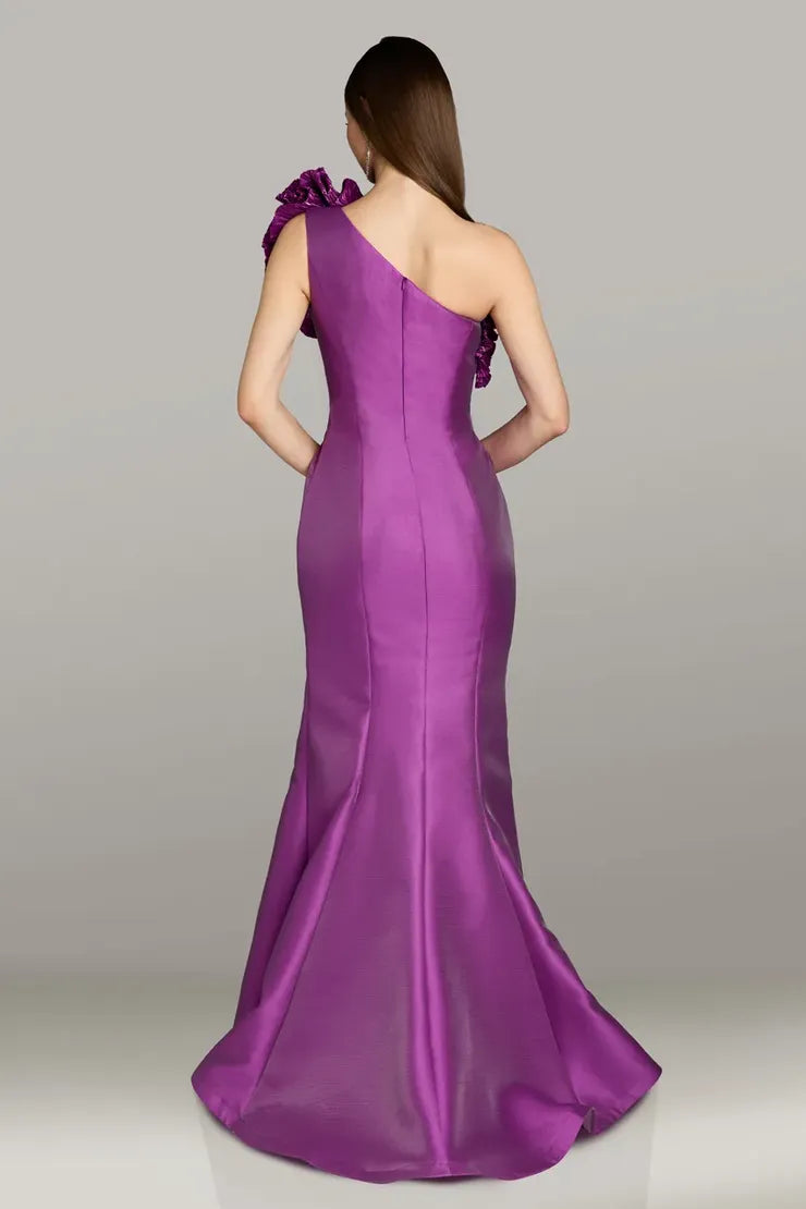 Model wearing Gia Franco 18554 one-shoulder gown with dramatic ruffle neckline and fit-and-flare silhouette.