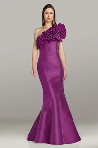 Model wearing Gia Franco 18554 one-shoulder gown with dramatic ruffle neckline and fit-and-flare silhouette.