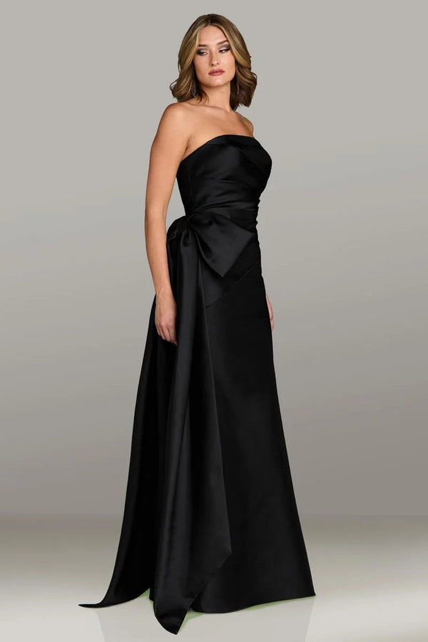 Gio Franco 12536 strapless gown with a draped bodice, side bow accent, and full-length silhouette. Ideal for formal evenings and weddings.  Model is wearing the color black.