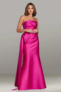 Gio Franco 12536 strapless gown with a draped bodice, side bow accent, and full-length silhouette. Ideal for formal evenings and weddings.  Model is wearing the color magenta.