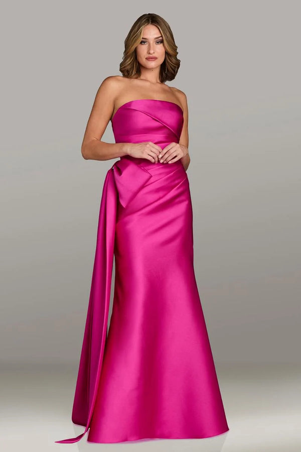 Gio Franco 12536 strapless gown with a draped bodice, side bow accent, and full-length silhouette. Ideal for formal evenings and weddings.  Model is wearing the color magenta.